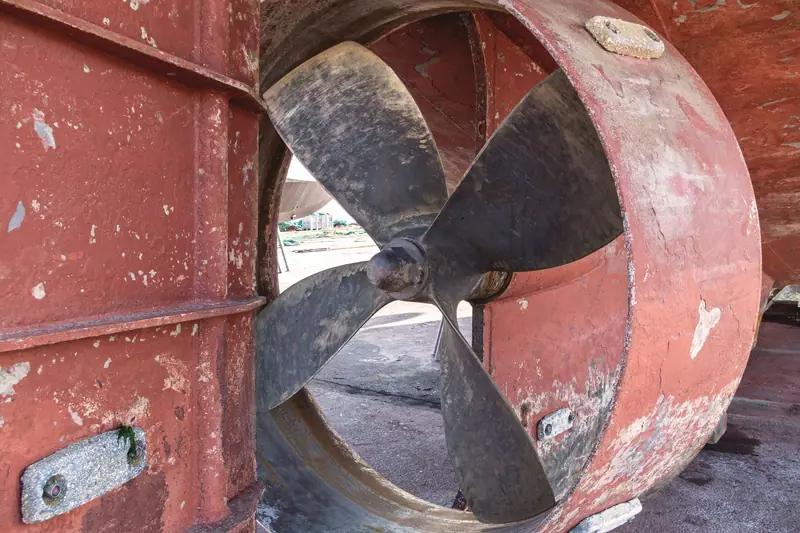 Sacrificial anodes bolted to a ship hull around a thruster